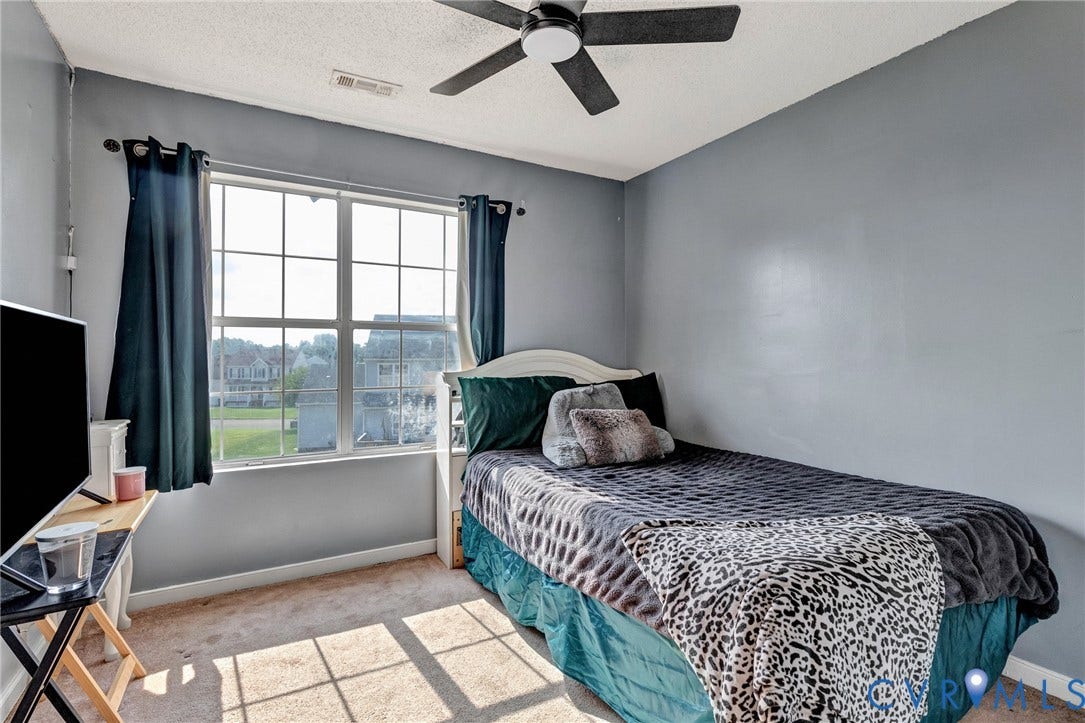 1601 Varina Station Court, Henrico, VA 23231 Carpeted room featuring a ceiling fan, a window with grid panes, and a white headboard
