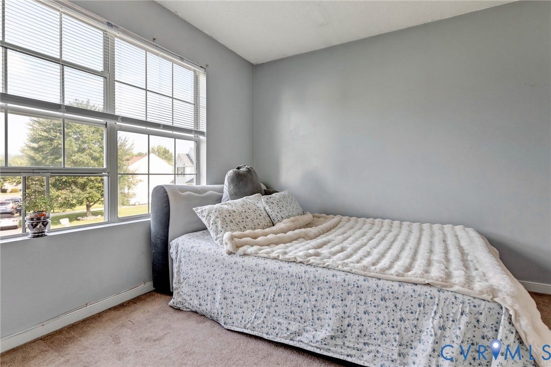 1601 Varina Station Court, Henrico, VA 23231 Large multi-pane window with horizontal blinds, sloped ceiling, and neutral wall color