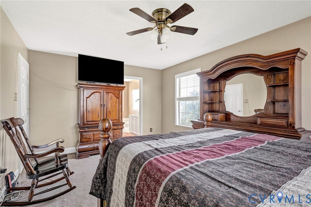 1601 Varina Station Court, Henrico, VA 23231 Ceiling fan with light fixture, window with blinds, carpeted flooring, and neutral wall paint