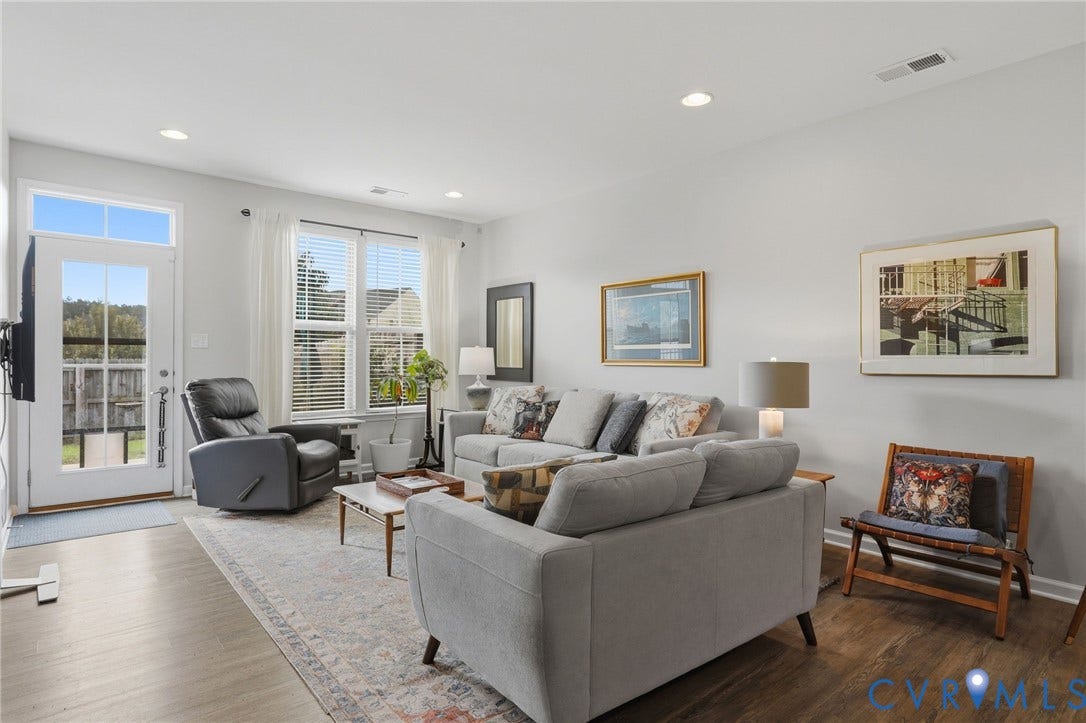 10653 Braden Parke Drive, Midlothian, VA 23832 Spacious living area featuring wood-finish flooring, recessed lighting, and ample natural light from multiple windows