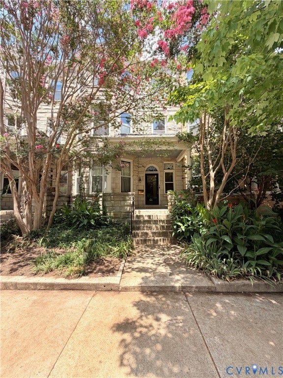 1620 Grove Avenue, #1, Richmond, VA 23220 Stone facade residence with a recessed entry, arched doorway, and multi-paned windows