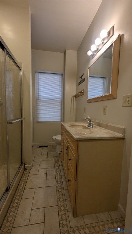 1620 Grove Avenue, #1, Richmond, VA 23220 Bathroom featuring a light-toned vanity with an integrated sink, a mirrored medicine cabinet with vanity lighting, and a shower enclosure