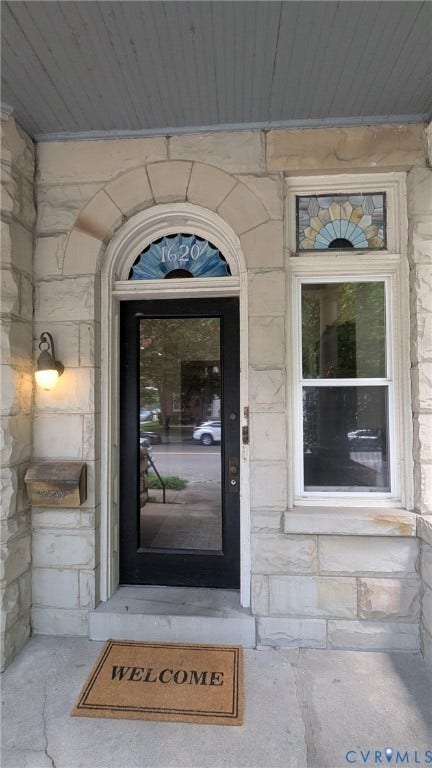 1620 Grove Avenue, #1, Richmond, VA 23220 Stone facade featuring an arched entryway with a transom window and stained glass accents