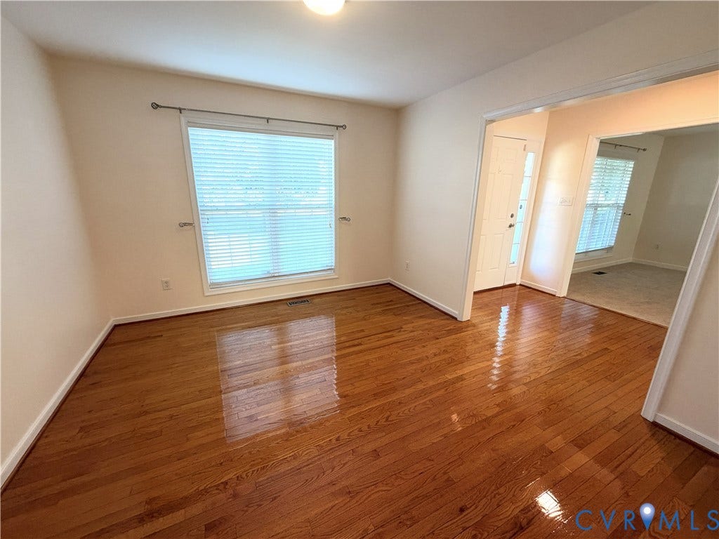 Hardwood flooring, recessed lighting, and a large window with blinds
