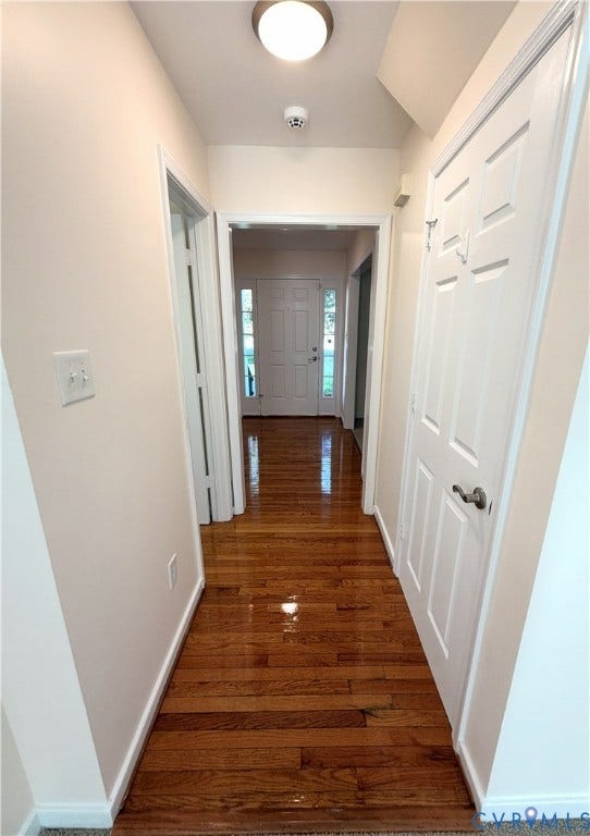 Warm wood-finish flooring throughout the hallway