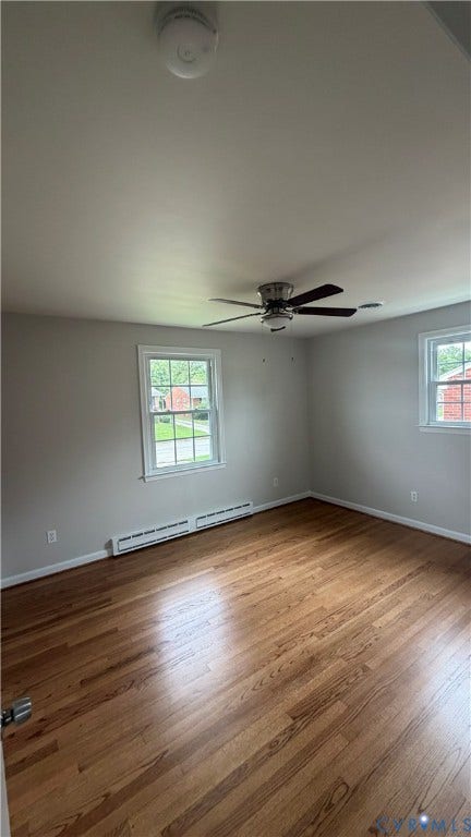 207 Mac Arthur Avenue, Gregory, Colonial Heights, VA 23834 Spacious room featuring wood-finish flooring, two large windows with white trim, and a ceiling fan with integrated lighting