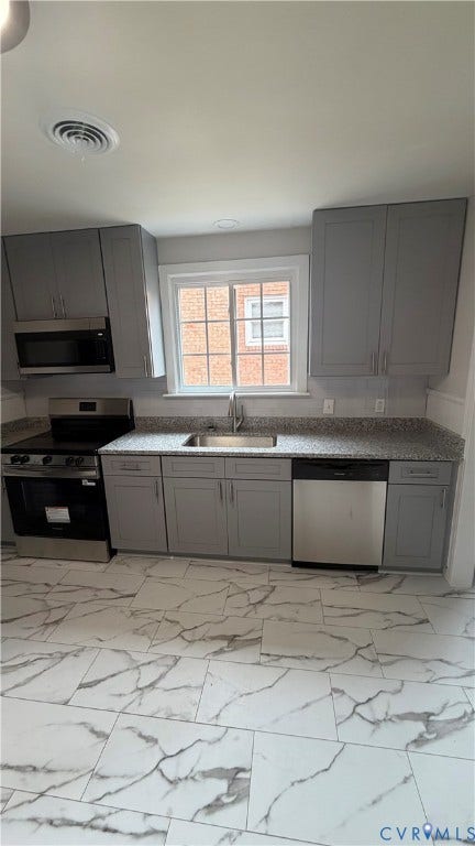 207 Mac Arthur Avenue, Gregory, Colonial Heights, VA 23834 Renovated kitchen featuring grey shaker-style cabinetry, granite-finish countertops, stainless steel appliances, and a modern tile floor
