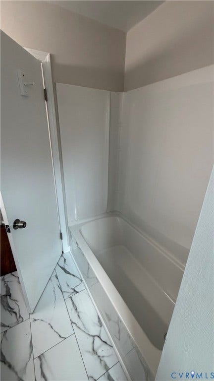 207 Mac Arthur Avenue, Gregory, Colonial Heights, VA 23834 Full-size bathtub with surrounding wall panels, complemented by white and grey patterned floor tiling