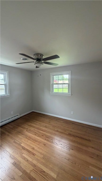 207 Mac Arthur Avenue, Gregory, Colonial Heights, VA 23834 Spacious room featuring wood-finish flooring, two windows, baseboard heating, and a ceiling fan with integrated lighting