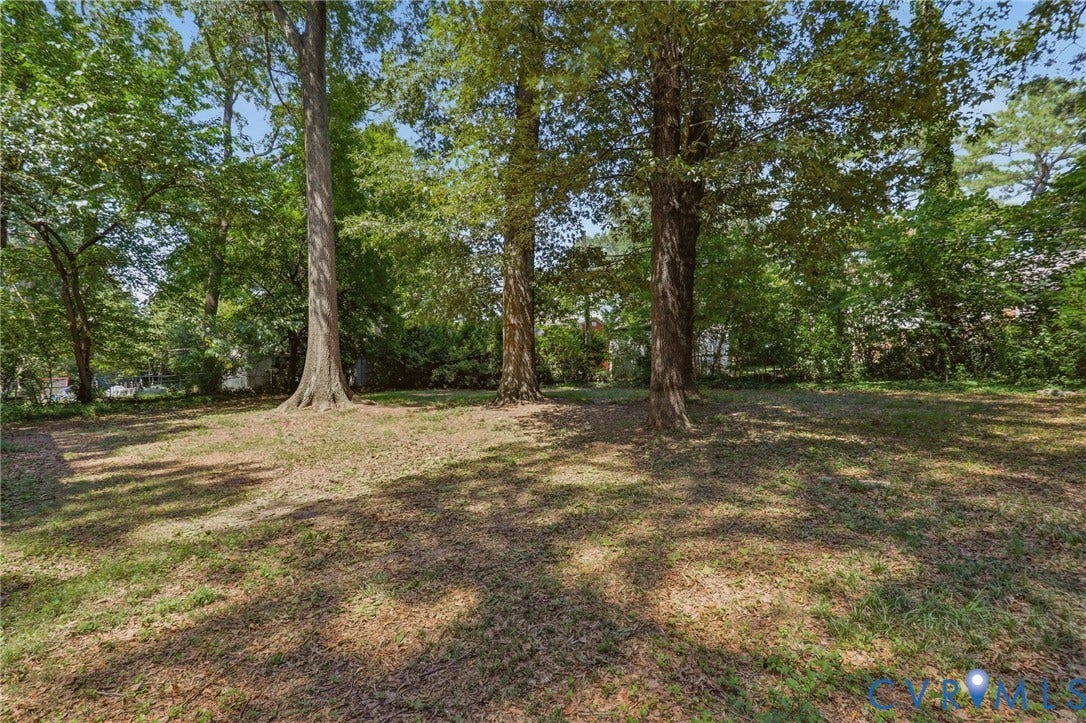 Expansive yard with mature trees providing ample shade