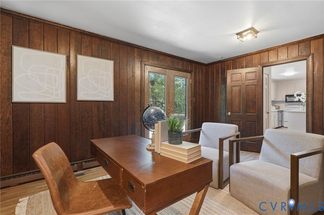 Room featuring wood paneling, wood-finish flooring, and a flush-mount ceiling light