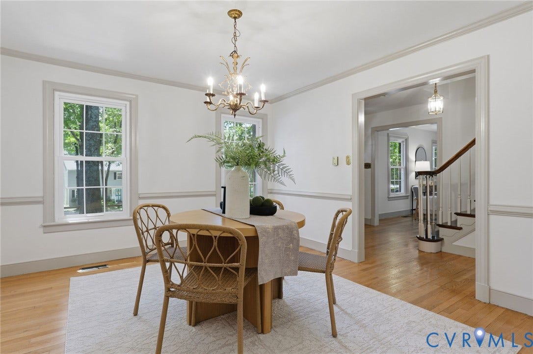Interior space featuring wood-finish flooring, white walls, and gray trim