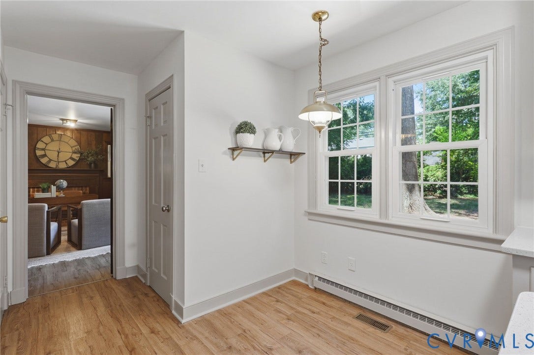Bright interior space featuring wood-finish flooring, white walls, and gray trim