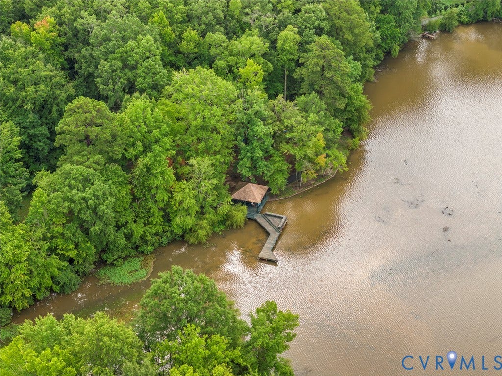 Wooded shoreline with a private dock and covered boat slip