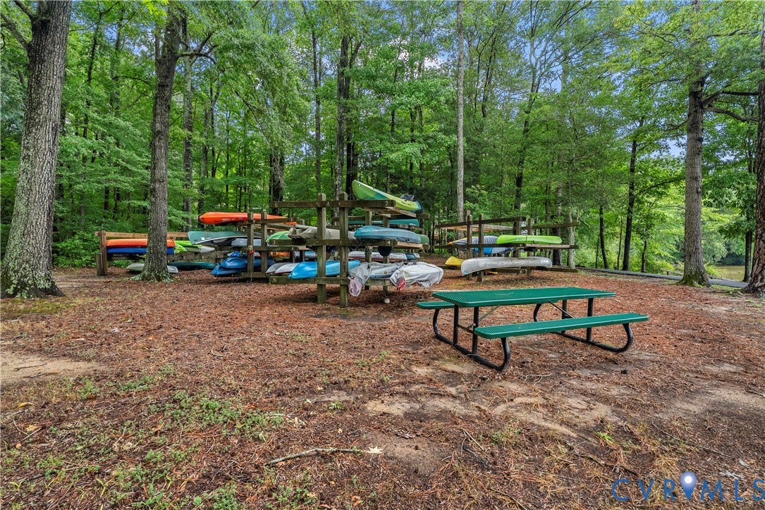 Wooded setting with multiple storage racks for kayaks and canoes