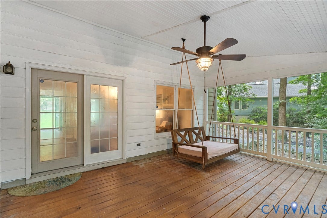 Expansive screened porch with wood-finish flooring, white shiplap walls, a beadboard ceiling, and a ceiling fan with integrated lighting
