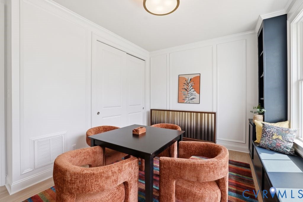 Built-in window seat with storage, integrated shelving, and panel molding