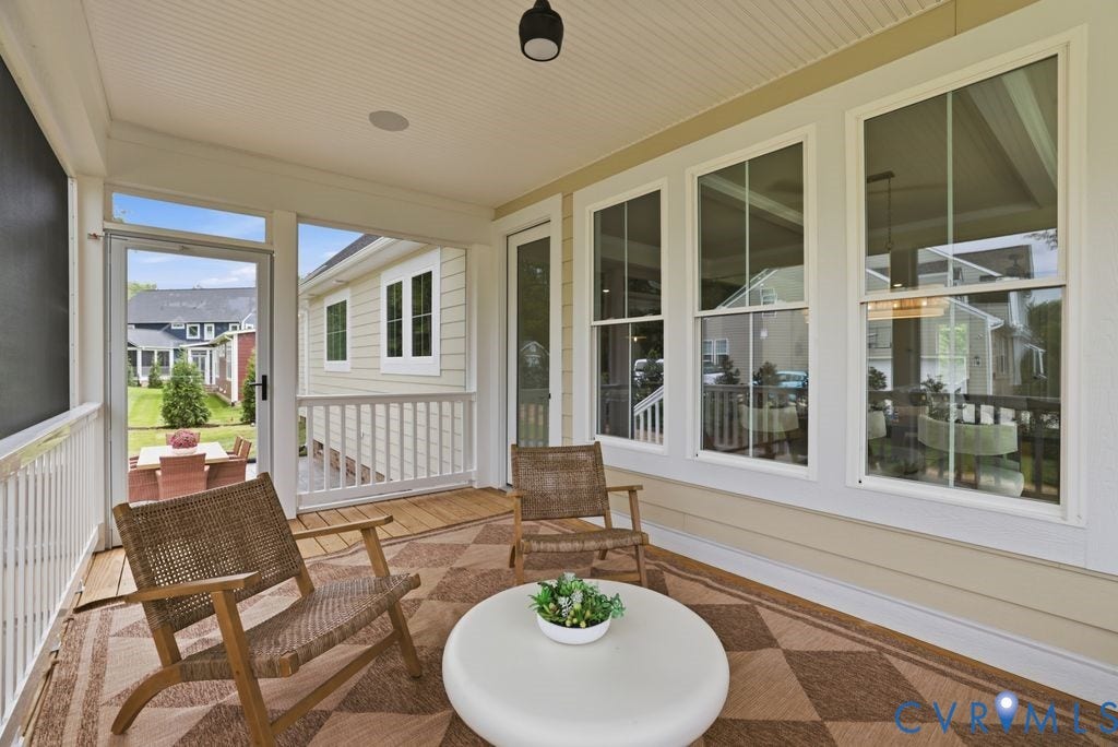 Spacious screened porch featuring beadboard ceiling, recessed lighting, and a durable checkered outdoor rug