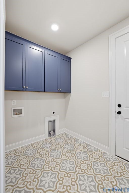 Utility space featuring patterned floor tile, blue shaker-style cabinetry, recessed ceiling lighting, and white baseboards