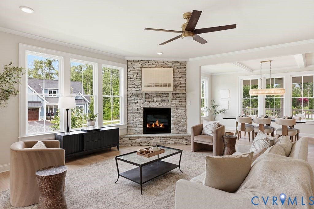 Expansive living area with a stone-clad fireplace and large windows