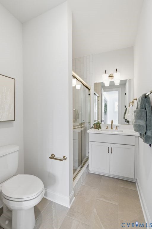 Full bathroom featuring a glass-enclosed shower with tile surround, a single vanity with storage, and contemporary lighting fixtures