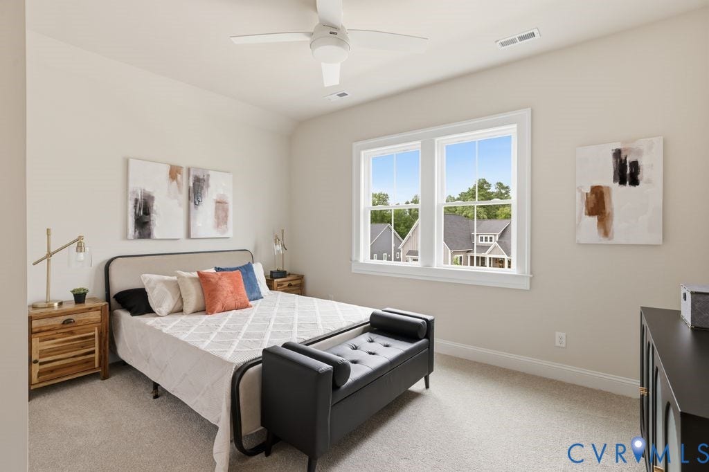 Bedroom featuring a ceiling fan, dual pane windows, and light neutral wall paint