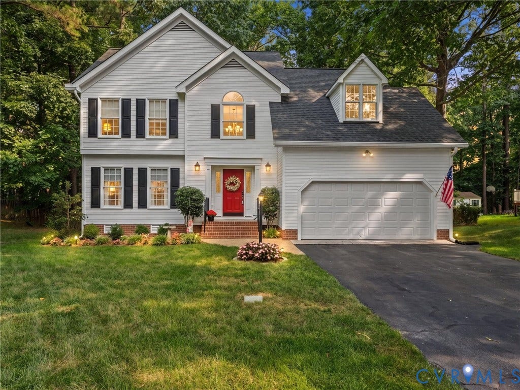 13915 Highpaige Way, Stoney Glen West, Chester, VA 23831 White siding exterior with a prominent red front door, black louvered shutters, and a two-car garage