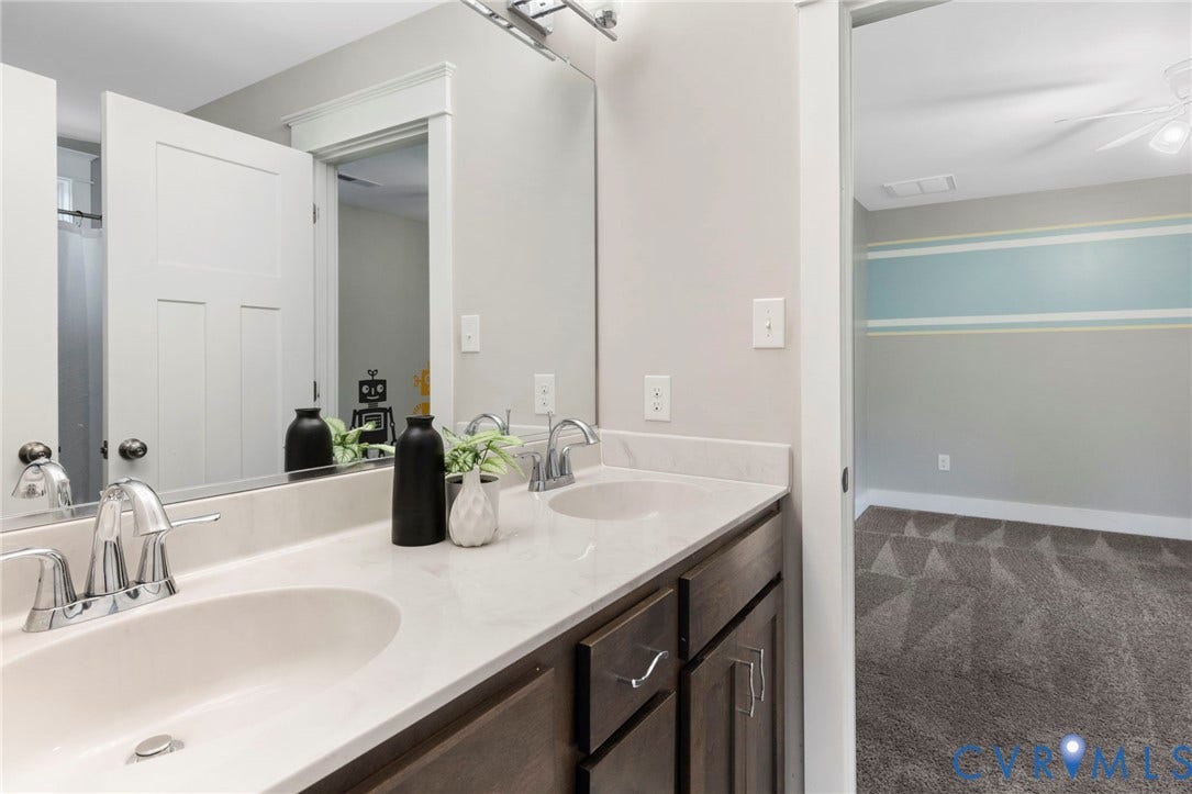 6984 Carden Park Drive, Moseley, VA 23120 Dual basin vanity with chrome fixtures and light-colored countertop