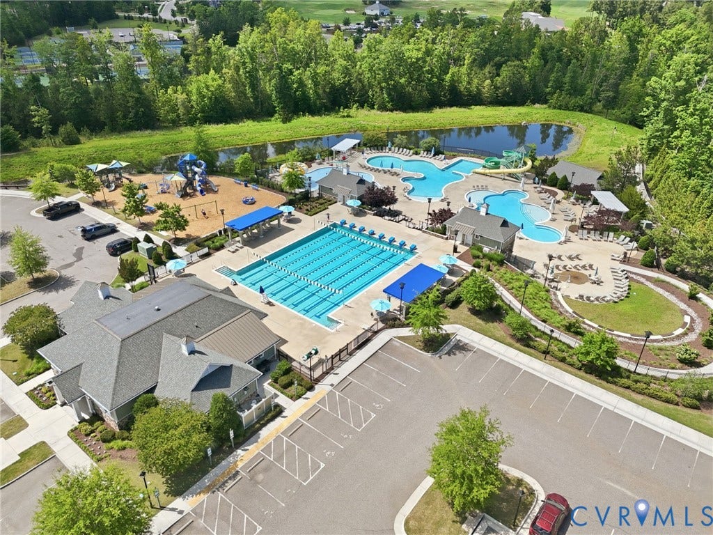 6984 Carden Park Drive, Moseley, VA 23120 Community amenity center featuring a multi-lane lap pool, a resort-style leisure pool with water slides, a dedicated children's play area, and extensive green spaces with walking paths