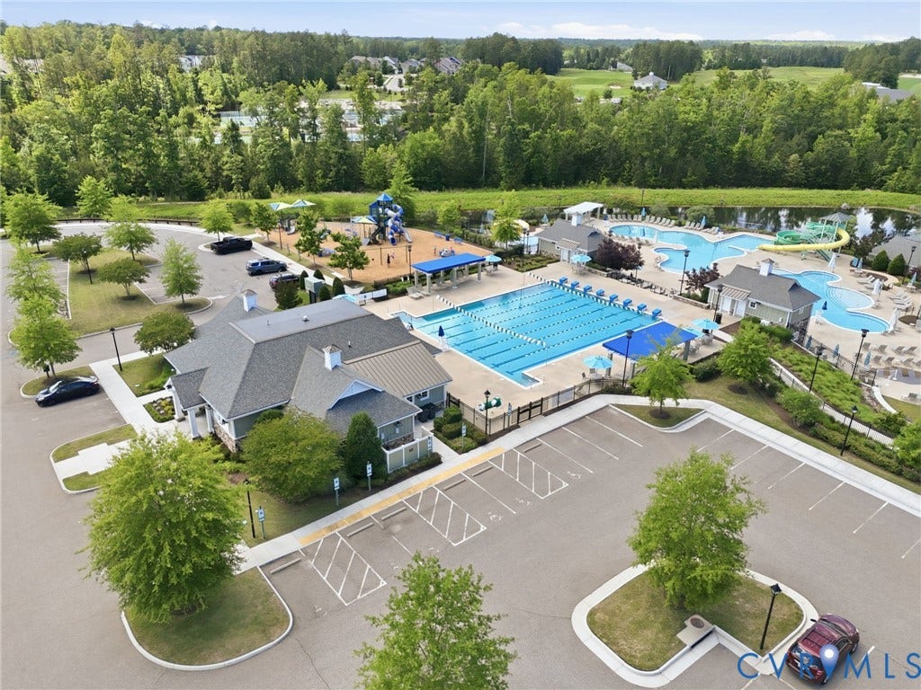 6984 Carden Park Drive, Moseley, VA 23120 Community amenities featuring a large clubhouse, multiple swimming pools, a dedicated lap pool, an aquatic play structure, and a playground