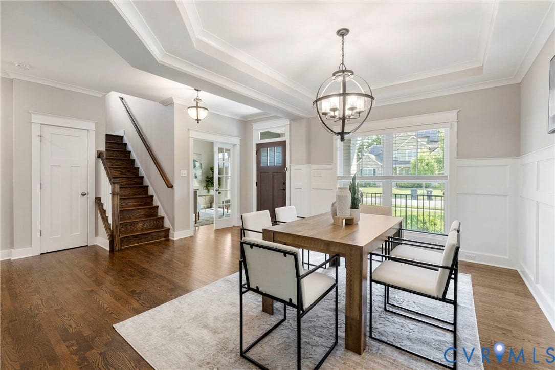 6984 Carden Park Drive, Moseley, VA 23120 Dining areaOpen-concept living and dining areas featuring site finished hard wood-flooring, white wainscoting, and tray ceilings.