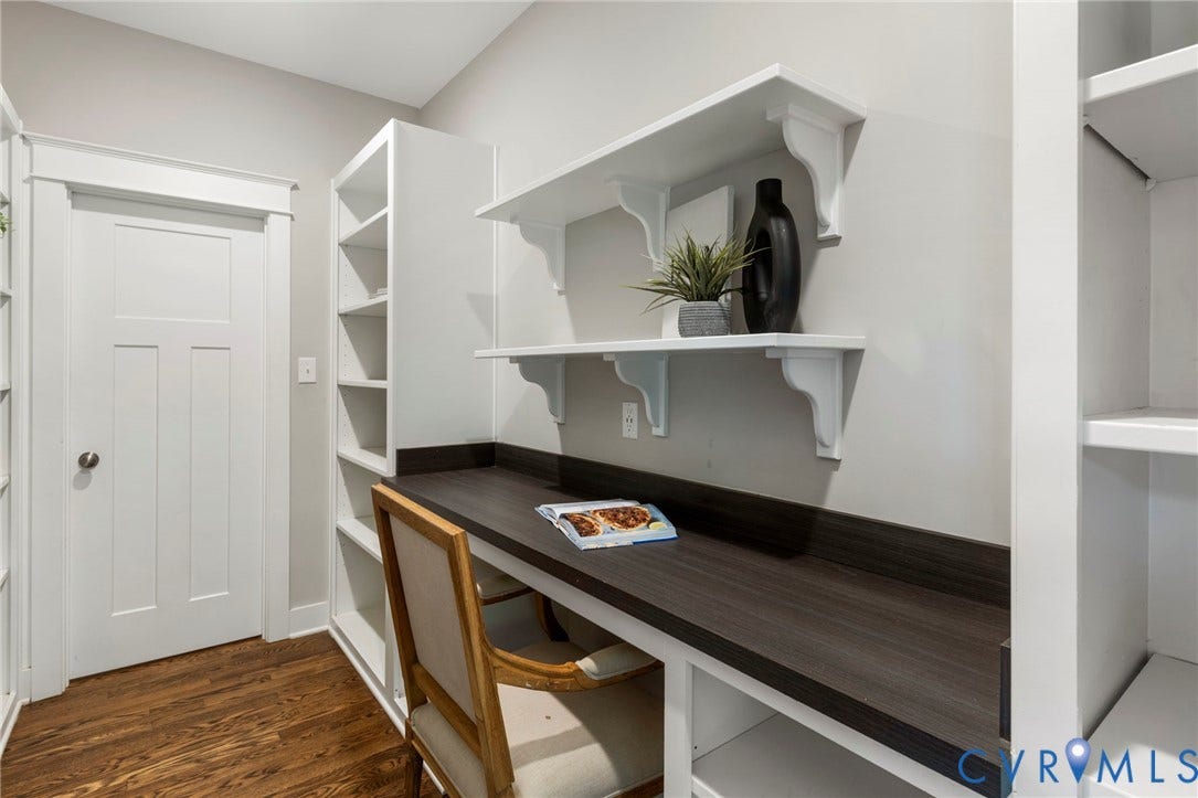 6984 Carden Park Drive, Moseley, VA 23120 Walk through panty, White built-in shelving with adjustable shelves, hardwood-finish flooring, and built in desk.