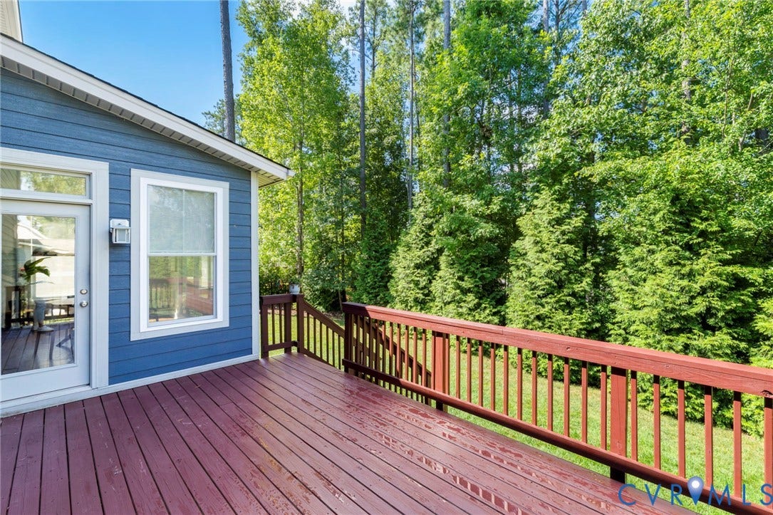 6984 Carden Park Drive, Moseley, VA 23120 Expansive wooden deck featuring a rich reddish-brown finish and matching railings