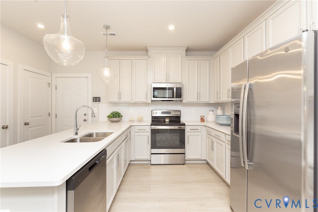 1041 N Lombardy Street, #A, Carver Square, Richmond, VA 23220 Spacious kitchen featuring light cabinetry, stainless steel appliances, &white countertops.