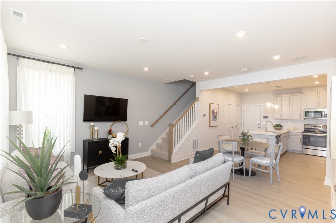 1041 N Lombardy Street, #A, Carver Square, Richmond, VA 23220 Open-concept living area featuring, recessed lighting, a white kitchen island with pendant lighting, stainless steel appliances, & a staircase with white balusters