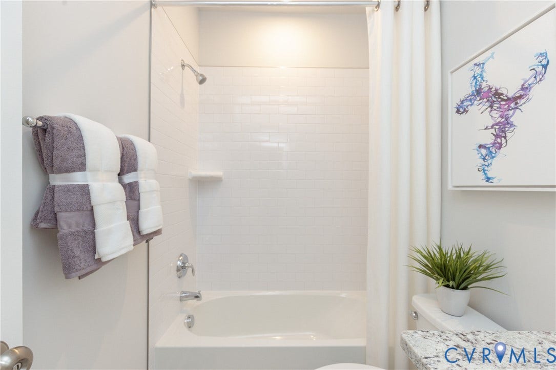 1041 N Lombardy Street, #A, Carver Square, Richmond, VA 23220 White subway tile shower surround with chrome fixtures and a built-in soap dish