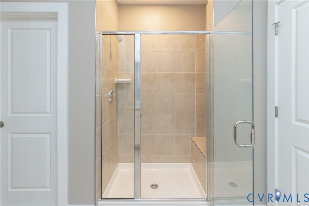 1041 N Lombardy Street, #A, Carver Square, Richmond, VA 23220 Glass-enclosed shower with a tiled interior, built-in bench,