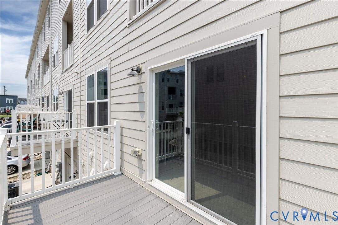 1041 N Lombardy Street, #A, Carver Square, Richmond, VA 23220 Private balcony featuring composite decking, white railing, and exterior wall lighting