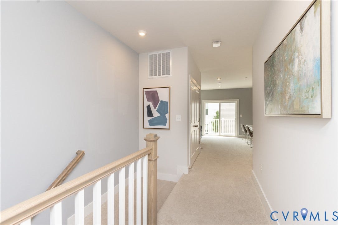1041 N Lombardy Street, #A, Carver Square, Richmond, VA 23220 Light-toned carpeted hallway featuring recessed lighting and a sliding glass door leading to a balcony with white railings