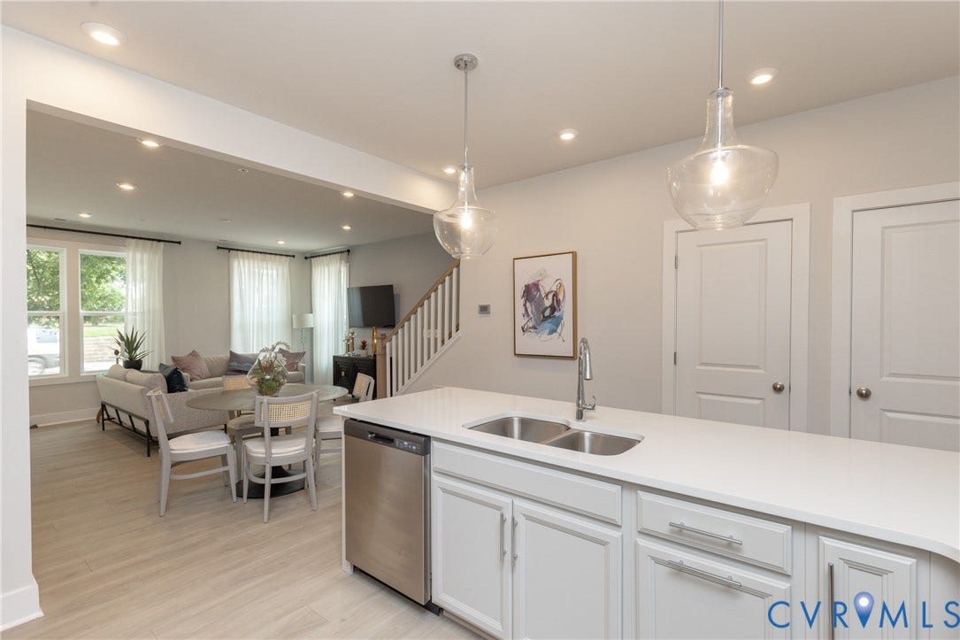 1041 N Lombardy Street, #A, Carver Square, Richmond, VA 23220 Kitchen island featuring a double basin stainless steel sink, contemporary faucet, & white countertop