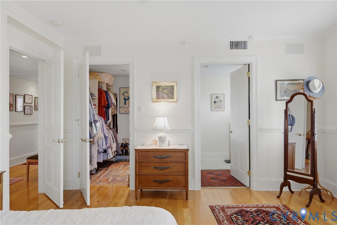 Interior room featuring light wood-finish flooring and white walls with wainscoting