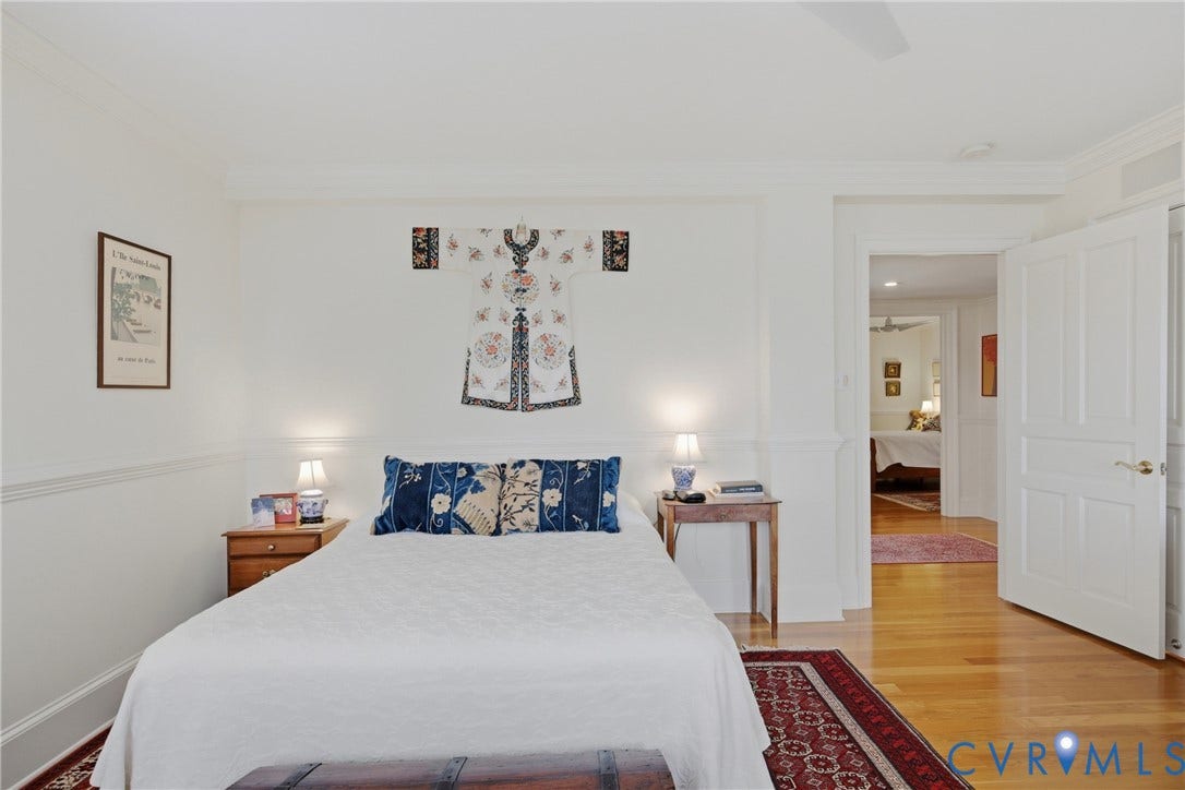 Hardwood flooring throughout, featuring crisp white walls and crown molding