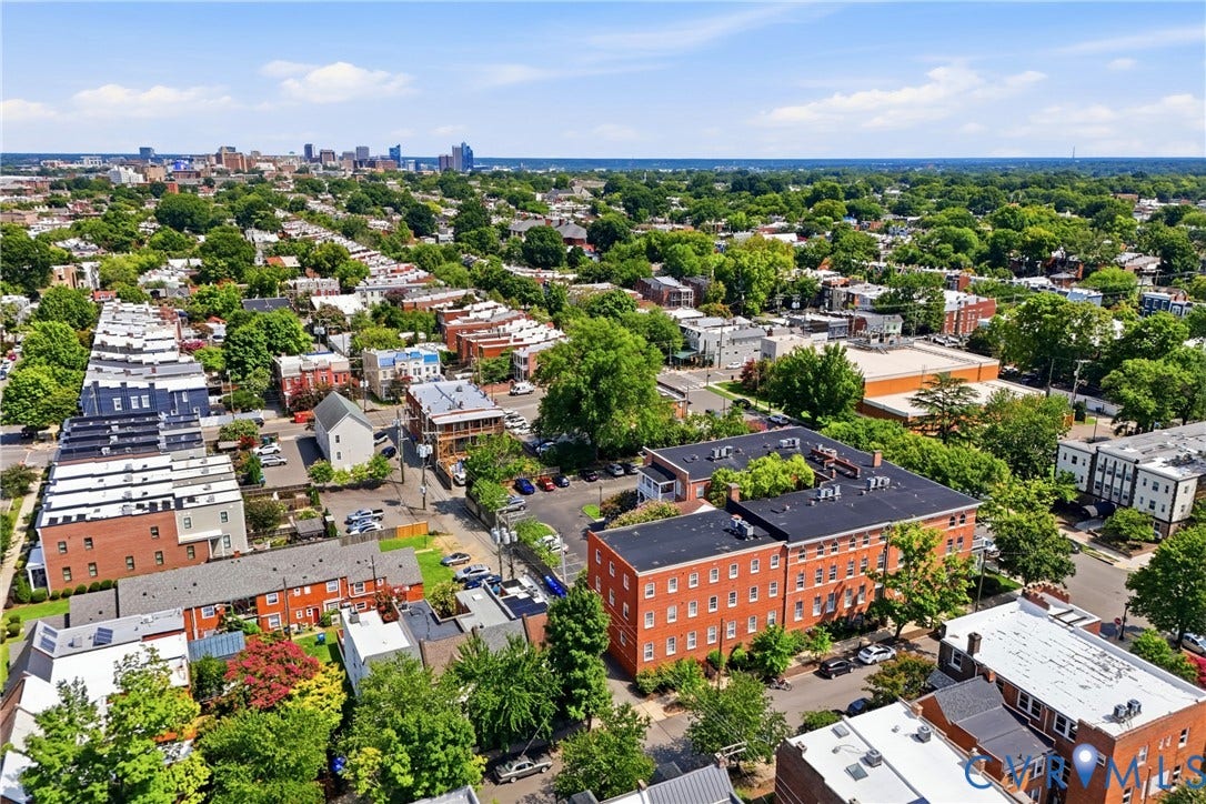 Aerial perspective showcasing a vibrant urban landscape with extensive tree canopies