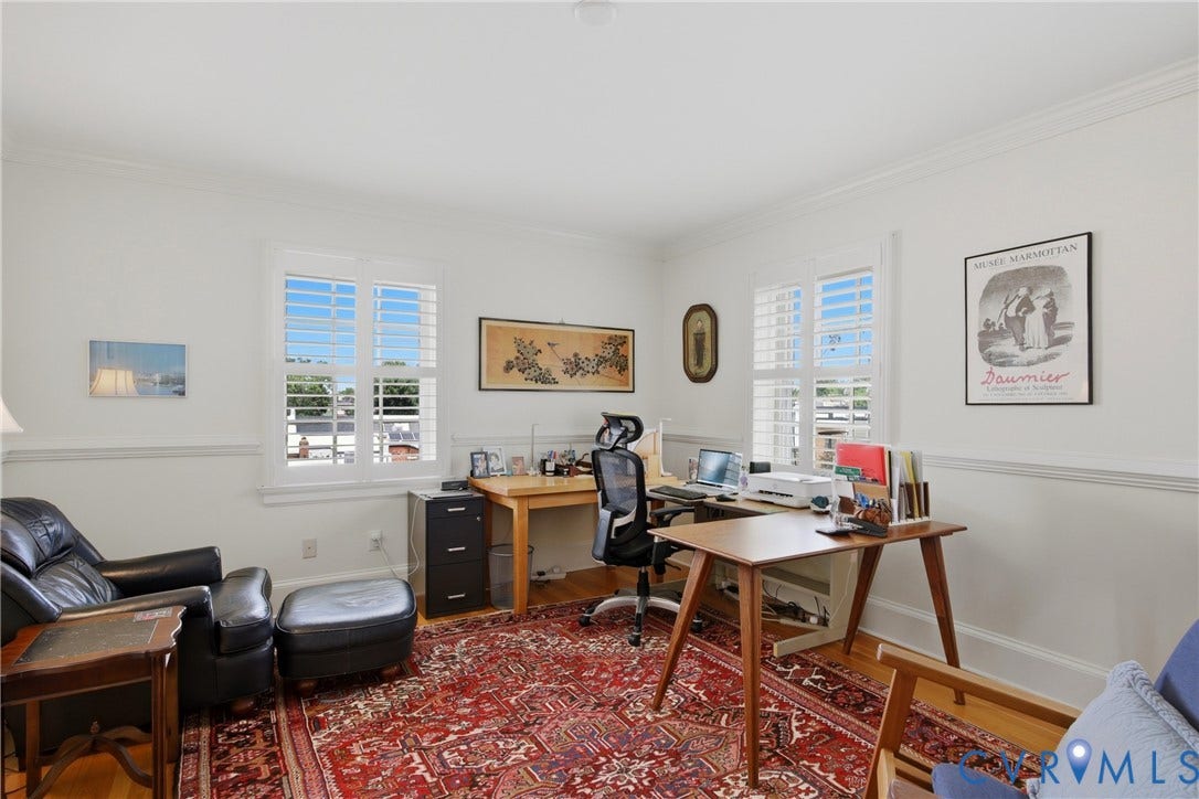 Interior room featuring white walls, crown molding, and wood-finish flooring