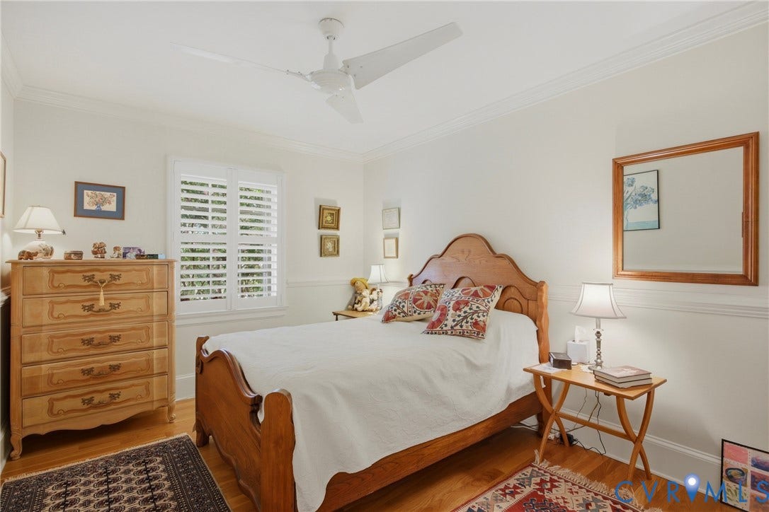 Interior room featuring light-colored walls and wood-finish flooring