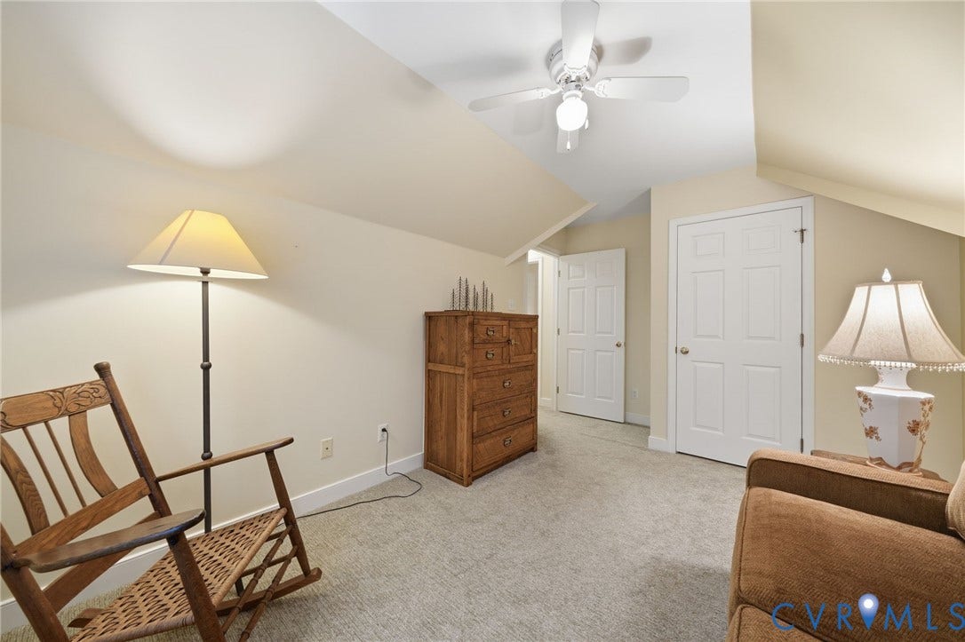 1902 Soldiers Lane, Crozier, VA 23039 Carpeted room with sloped ceilings and a ceiling fan
