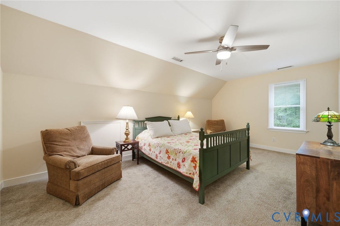 1902 Soldiers Lane, Crozier, VA 23039 Carpeted room featuring a window with white trim, sloped ceiling, ceiling fan with integrated lighting, and light-toned walls