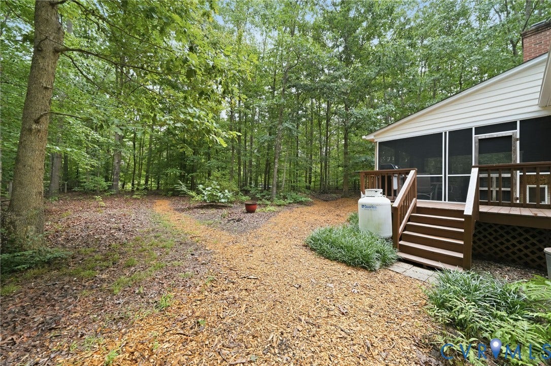 1902 Soldiers Lane, Crozier, VA 23039 Expansive wooded backyard with a screened porch and adjacent wooden deck