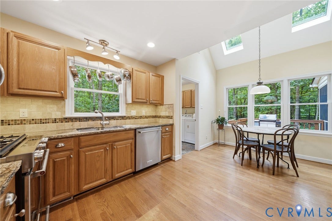 1902 Soldiers Lane, Crozier, VA 23039 Kitchen featuring wood-finish flooring, recessed lighting, and a vaulted ceiling with skylights
