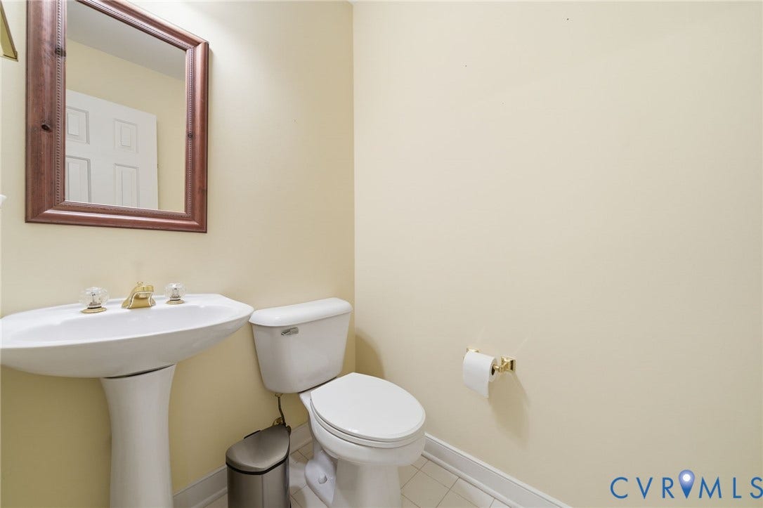 1902 Soldiers Lane, Crozier, VA 23039 Pedestal sink with brass-finish faucet, framed mirror, and tile flooring